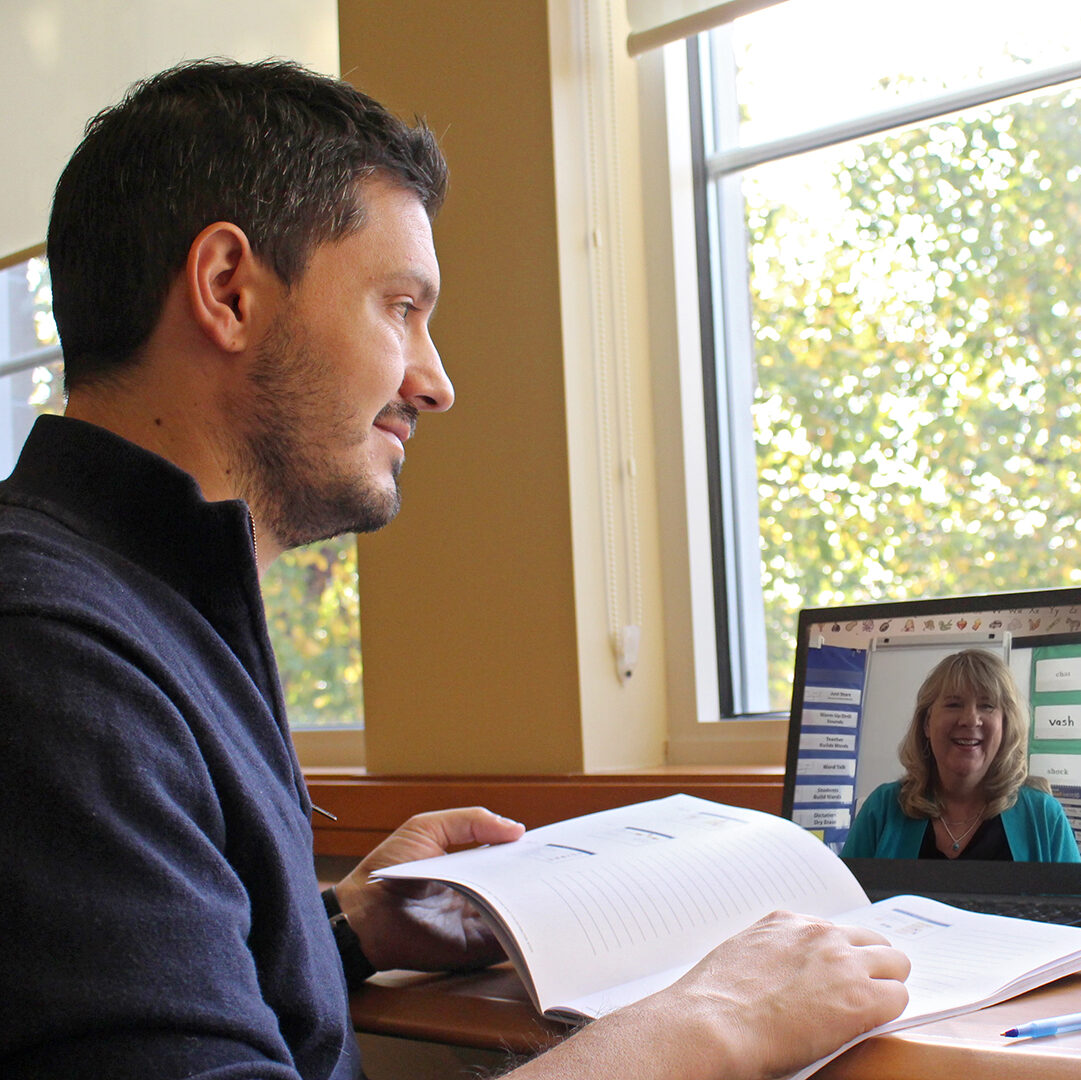 Man participating in online learning with a remote instructor, following the Wilson Way.