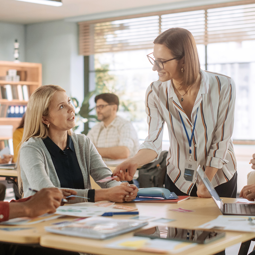 Teacher guides woman in dyslexia training session