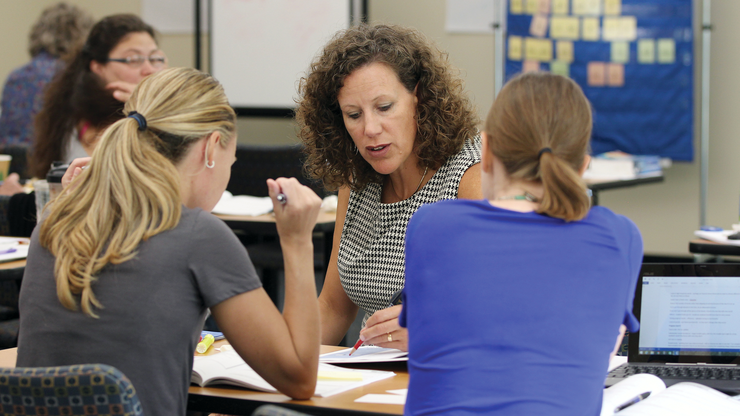 Educators collaborate on school literacy plans, discussing curriculum and student success.