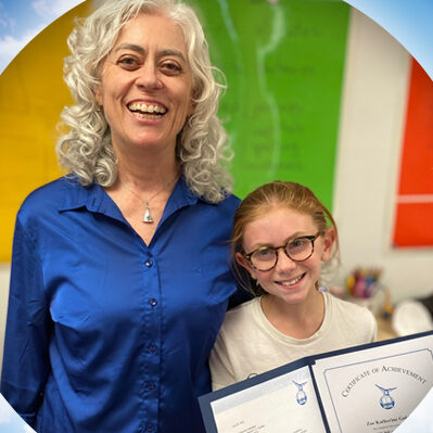 Teacher and student with Wilson Reading System® certificate of achievement.
