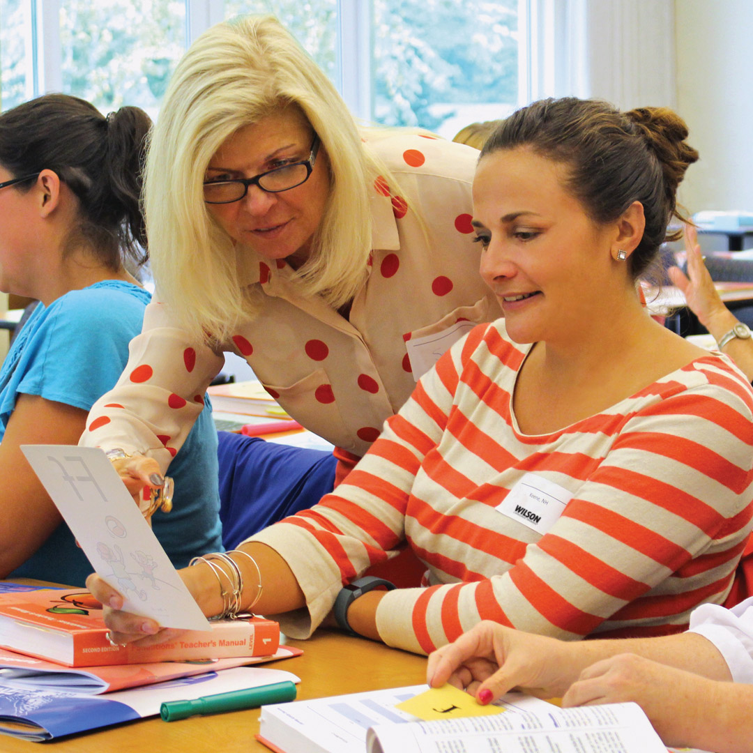 Teacher guiding student with structured literacy lesson on Science of Reading.