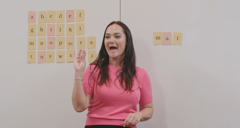 Teacher at a Fundations workshop pointing to alphabet cards and word cards.