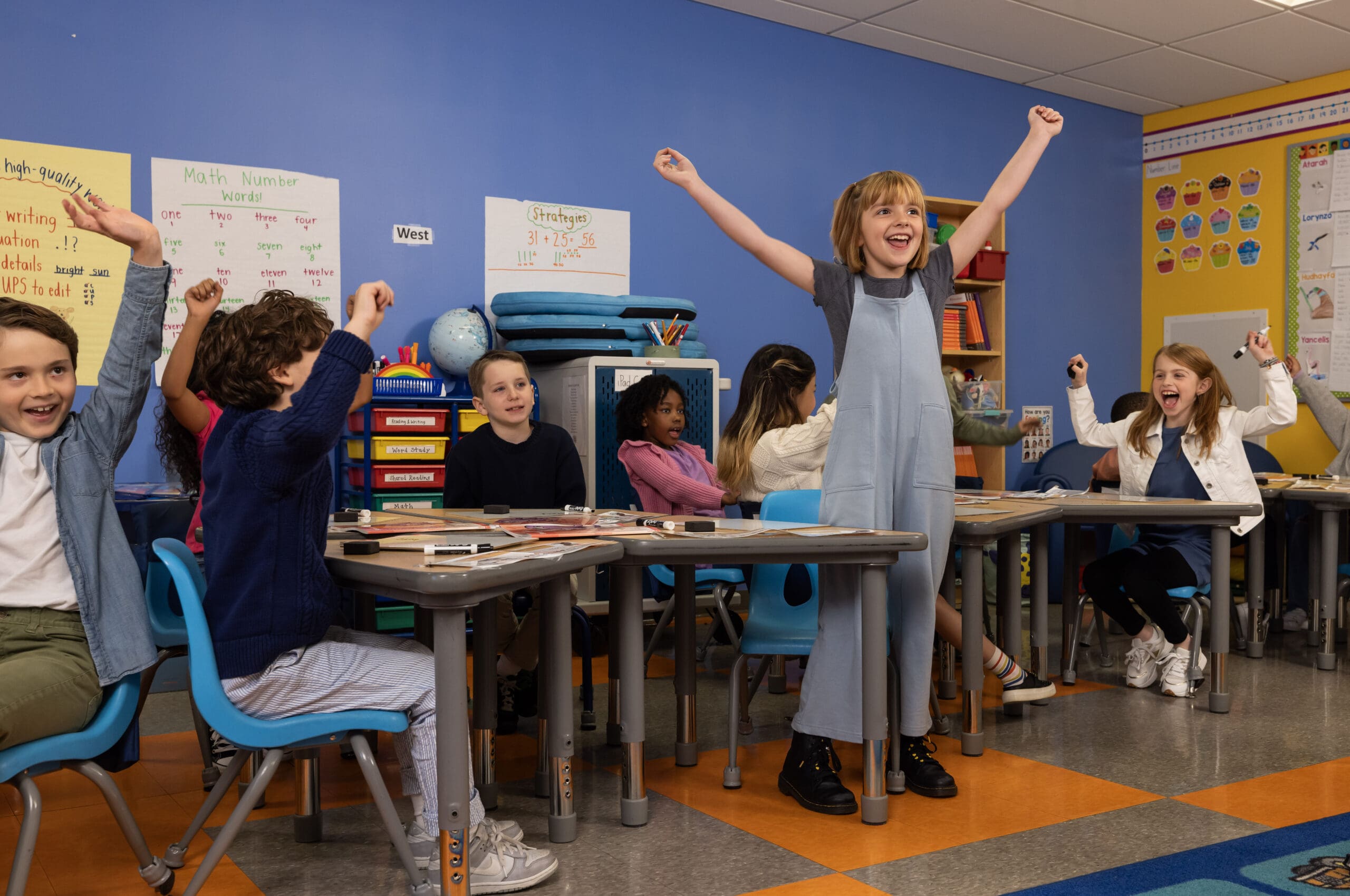 Young students in a classroom celebrating a math lesson with Fun Foundations K-3
