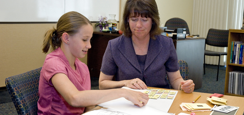 Dyslexia specialist works with student on reading intervention