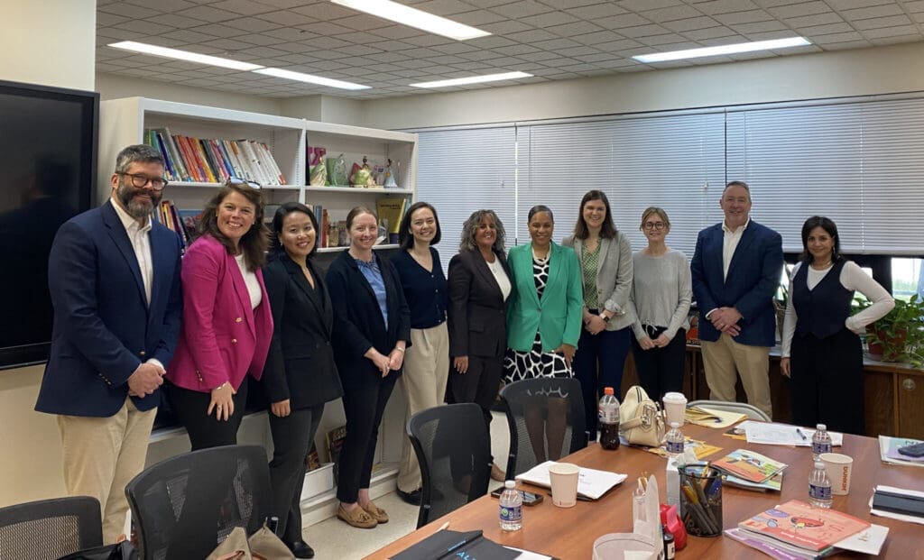 Diverse group of professionals in a meeting room discussing careers.