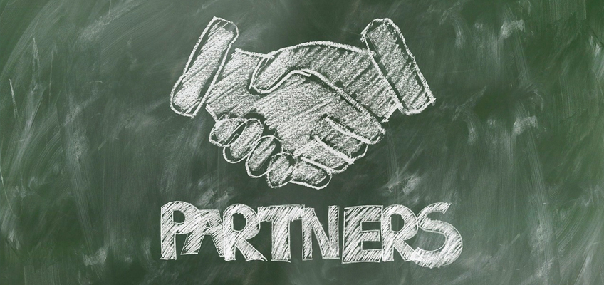 Chalk drawing of a handshake and the word