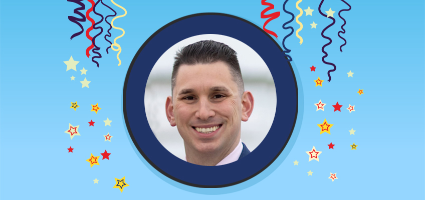 Portrait of a smiling male teacher, celebrating success in education.