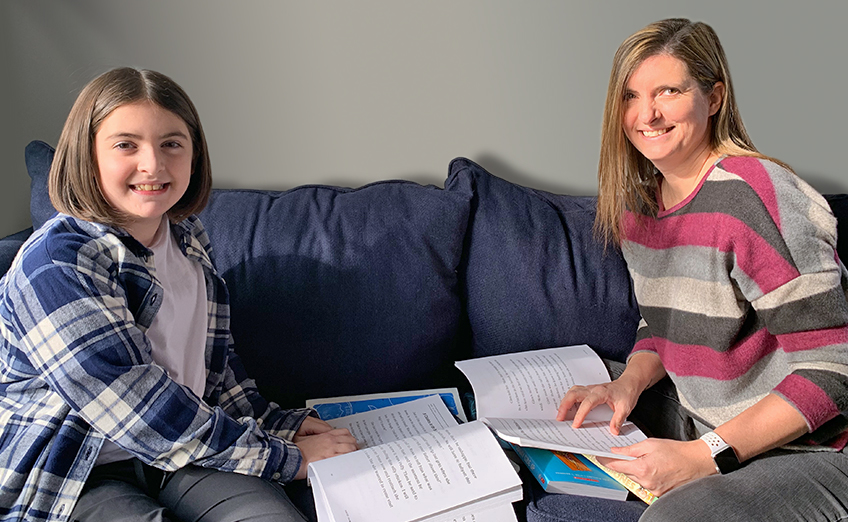 Mother and daughter building reading skills and confidence with books.