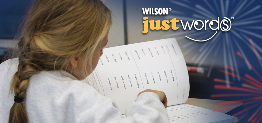 Young girl reads a Just Words® book, celebrating literacy and independence.