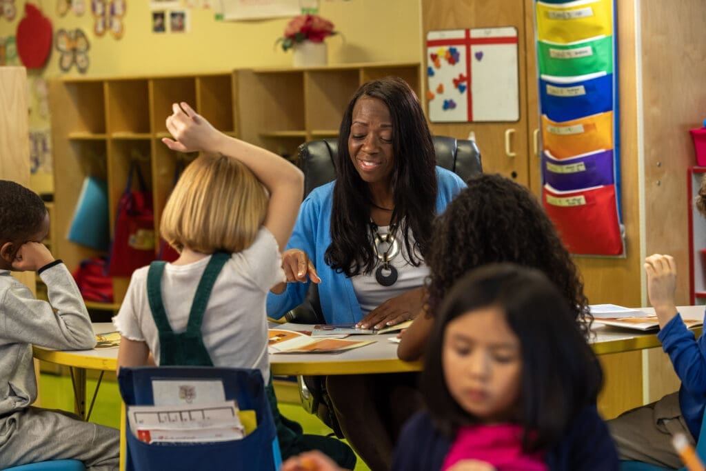 Diverse classroom: teacher interacting with young students during a lesson