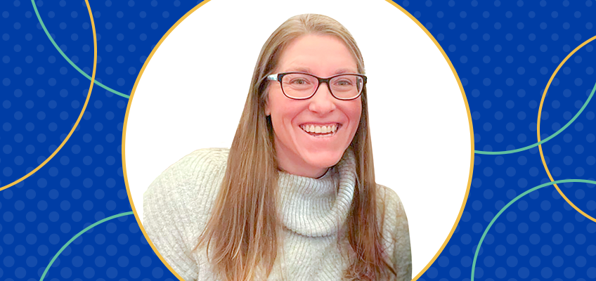 WRS Educator Sarah Smith smiles in a grey sweater and glasses.
